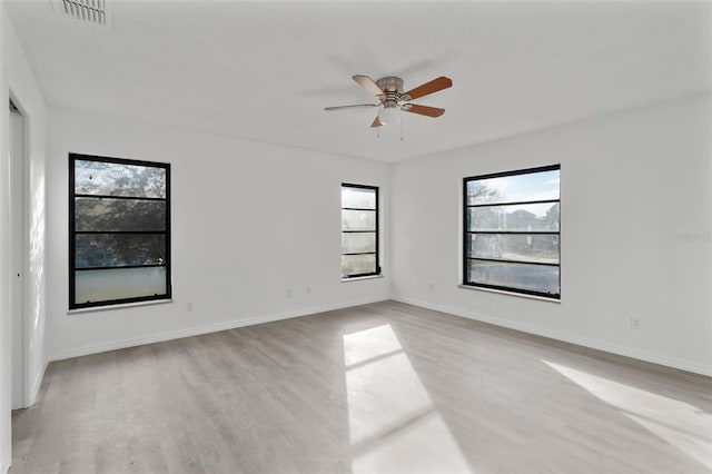 unfurnished room with ceiling fan and light wood-type flooring