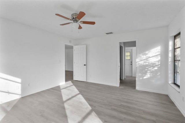 unfurnished room with ceiling fan, plenty of natural light, and light hardwood / wood-style floors