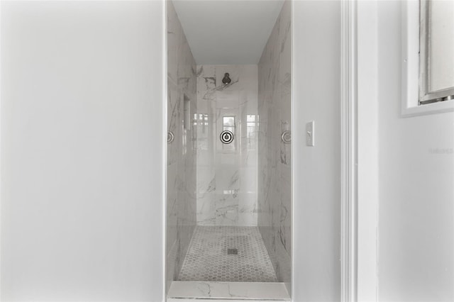 bathroom with a tile shower