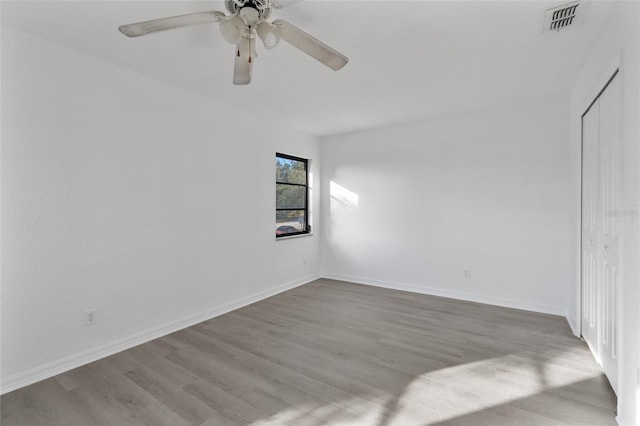 spare room with light hardwood / wood-style flooring and ceiling fan