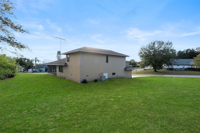 view of side of home featuring a lawn