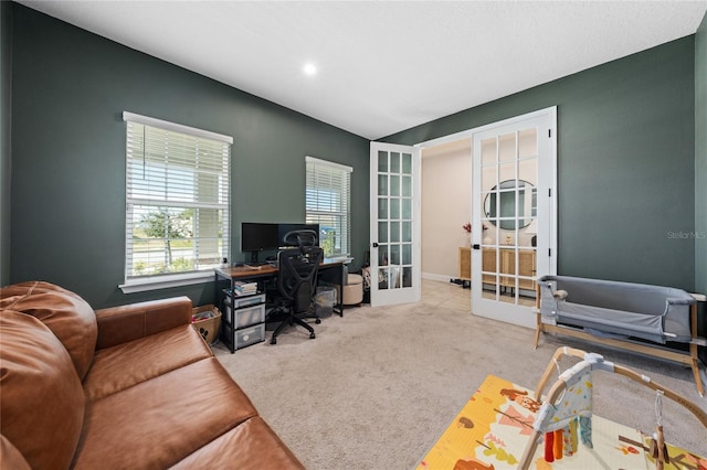 carpeted home office featuring french doors