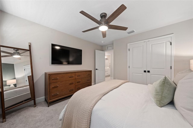 bedroom featuring light colored carpet, a closet, and ceiling fan