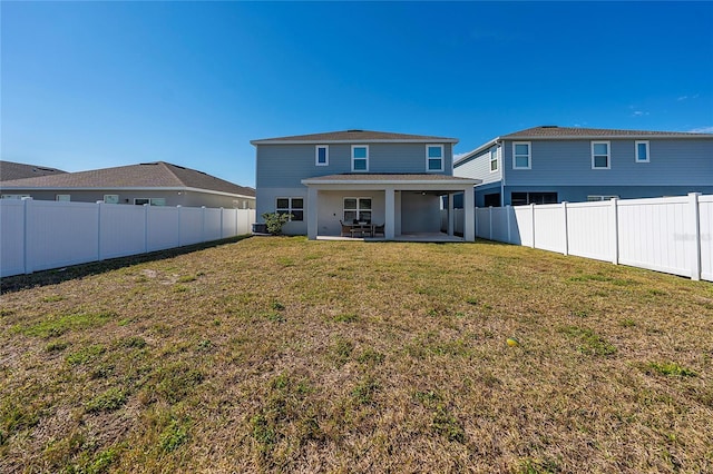 back of property with a patio and a lawn