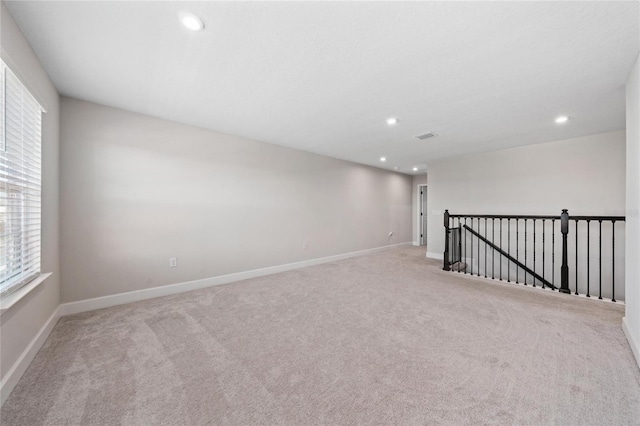 unfurnished room with light colored carpet