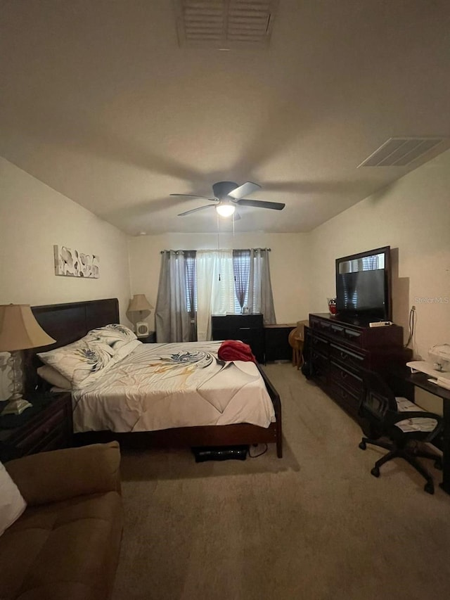 carpeted bedroom with vaulted ceiling and ceiling fan