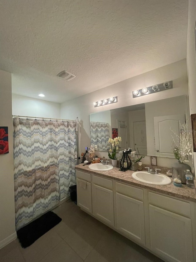 bathroom featuring vanity and a textured ceiling