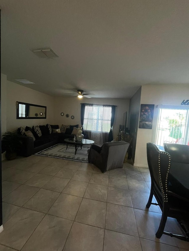 living room featuring light tile patterned floors and ceiling fan