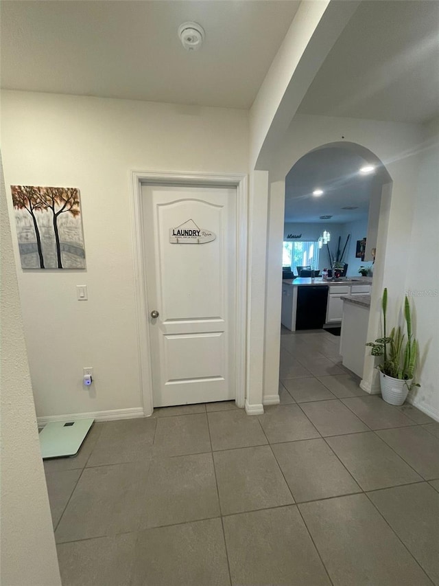 hall with light tile patterned floors