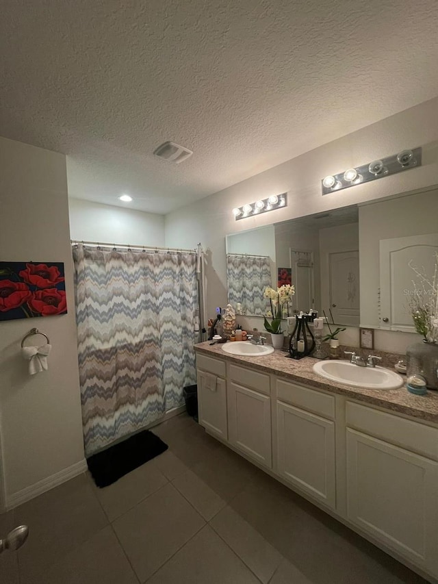 bathroom featuring a shower with curtain, vanity, tile patterned flooring, and a textured ceiling