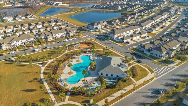 drone / aerial view with a water view and a residential view