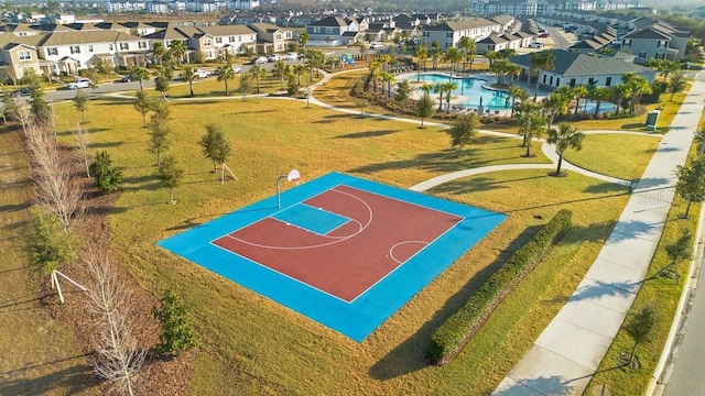 view of basketball court with a yard