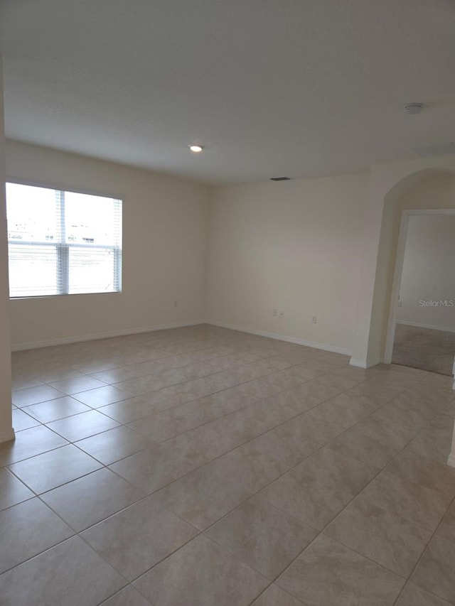 unfurnished room with light tile patterned floors