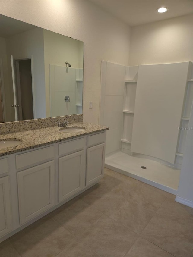 bathroom featuring vanity and a shower