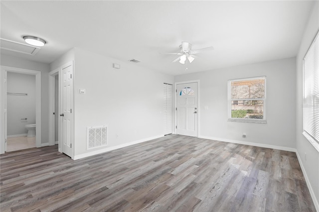 empty room with hardwood / wood-style flooring and ceiling fan