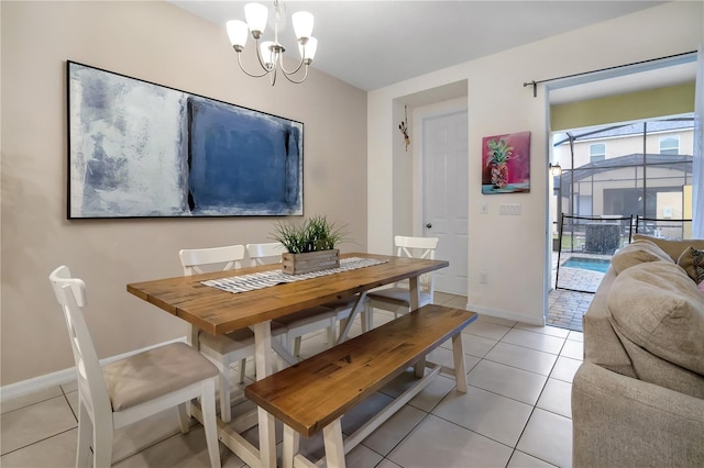 dining space with light tile patterned floors, baseboards, and a notable chandelier