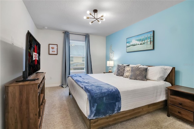 carpeted bedroom featuring a textured ceiling, baseboards, and a notable chandelier