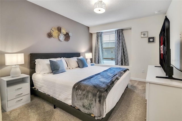 bedroom featuring baseboards and light colored carpet