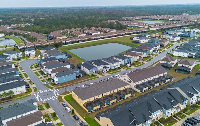 drone / aerial view featuring a residential view and a water view