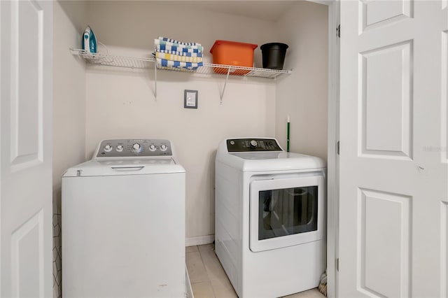 2186 Fleming Mist Pl, Kissimmee, FL 34747 - washroom featuring washer and clothes dryer and light tile patterned flooring