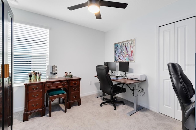 home office featuring light colored carpet and ceiling fan