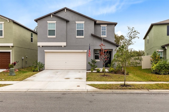 view of property featuring a garage and a front lawn