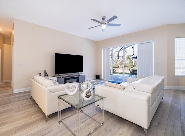 living room with light hardwood / wood-style flooring and ceiling fan