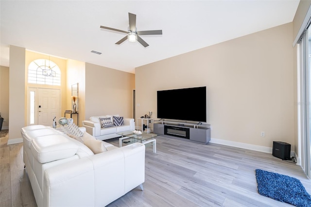 living room with ceiling fan and light wood-type flooring