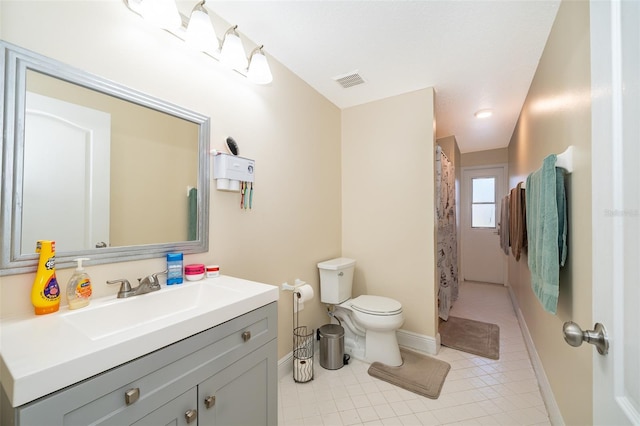 bathroom with vanity, curtained shower, tile patterned floors, and toilet