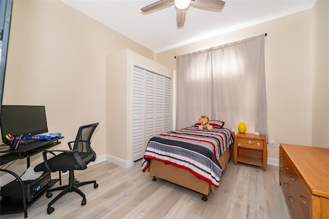 bedroom with ceiling fan, light hardwood / wood-style floors, and a closet