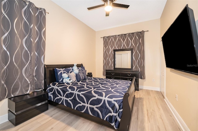 bedroom featuring ceiling fan, lofted ceiling, and light hardwood / wood-style floors