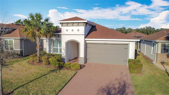 view of front of house featuring a garage and a front yard