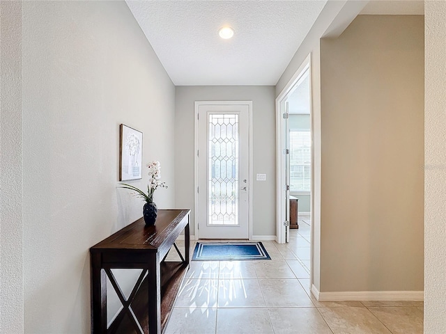 entrance foyer featuring light tile patterned flooring and a textured ceiling