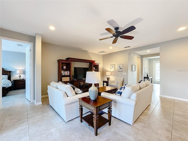 living room featuring ceiling fan and light tile patterned flooring