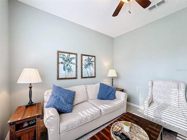 living room featuring wood-type flooring and ceiling fan