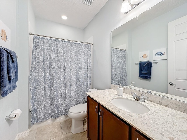 bathroom featuring vanity, toilet, tile patterned flooring, and a textured ceiling