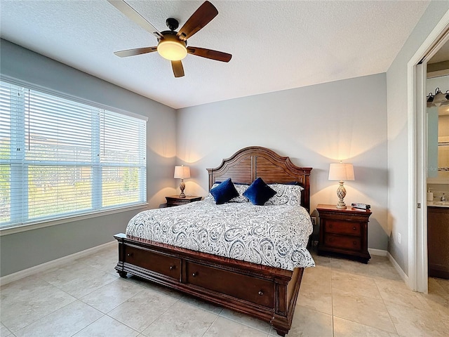 bedroom with ceiling fan, a textured ceiling, and light tile patterned floors