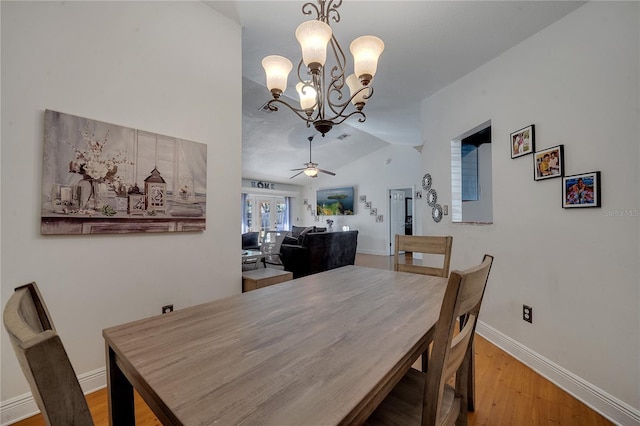 2417 Liela Lee Ct, Ocoee, FL 34761 - dining space with vaulted ceiling, ceiling fan with notable chandelier, and light hardwood / wood-style floors