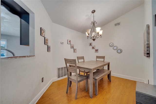 2417 Liela Lee Ct, Ocoee, FL 34761 - dining space with an inviting chandelier, light hardwood / wood-style flooring, and vaulted ceiling