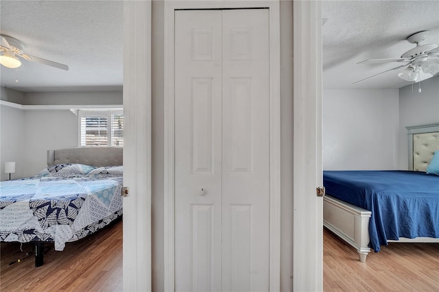 2417 Liela Lee Ct, Ocoee, FL 34761 - bedroom with ceiling fan, a textured ceiling, and light wood-type flooring