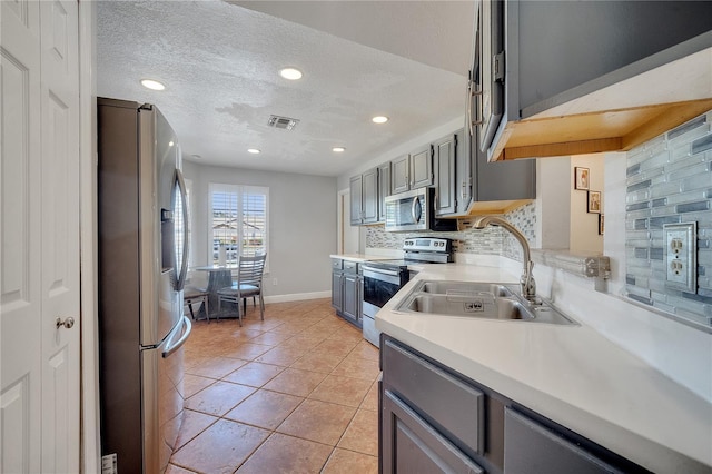 2417 Liela Lee Ct, Ocoee, FL 34761 - kitchen with sink, light tile patterned floors, gray cabinets, appliances with stainless steel finishes, and backsplash
