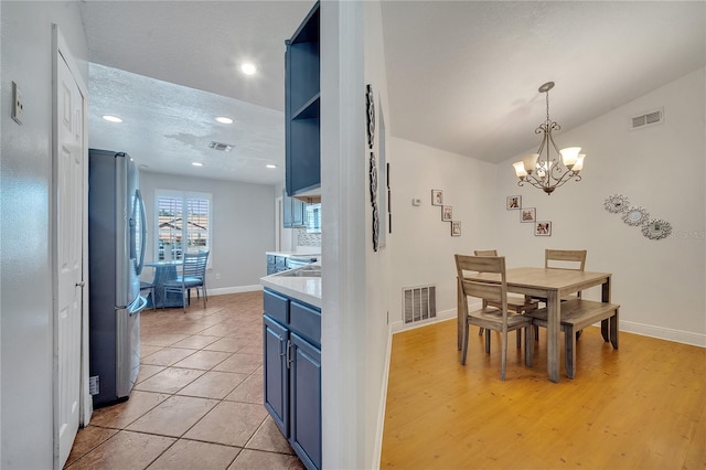2417 Liela Lee Ct, Ocoee, FL 34761 - dining space with an inviting chandelier, a textured ceiling, and light tile patterned floors