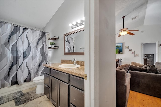 2417 Liela Lee Ct, Ocoee, FL 34761 - bathroom with vaulted ceiling, tile patterned flooring, vanity, ceiling fan, and toilet