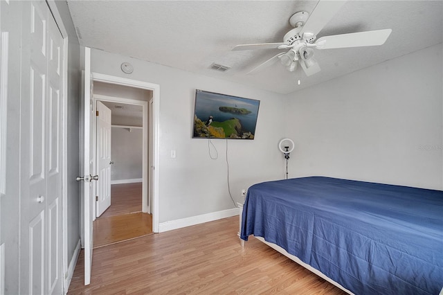 2417 Liela Lee Ct, Ocoee, FL 34761 - bedroom with hardwood / wood-style flooring, ceiling fan, a closet, and a textured ceiling