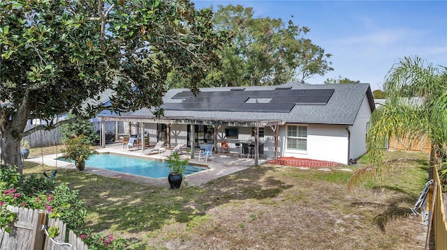 2417 Liela Lee Ct, Ocoee, FL 34761 - rear view of house with a fenced in pool, a lawn, a patio, and solar panels