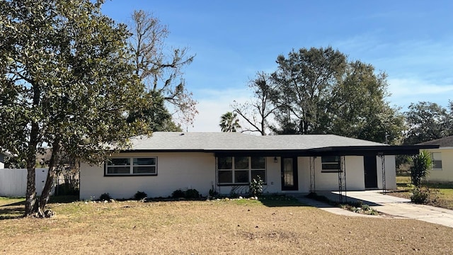 single story home with a front lawn and a carport