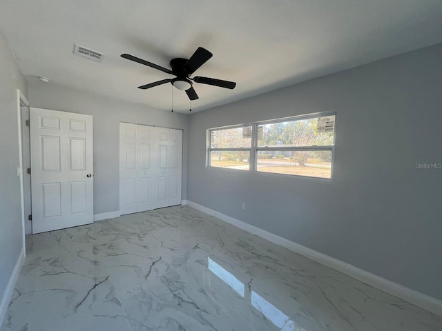 unfurnished bedroom featuring a closet and ceiling fan