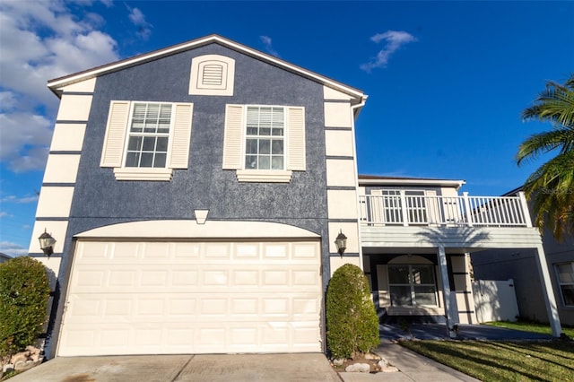 front of property featuring a garage and a balcony