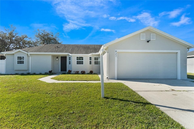 ranch-style home with a garage and a front yard