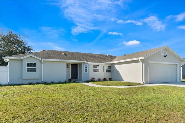 single story home with a garage and a front lawn